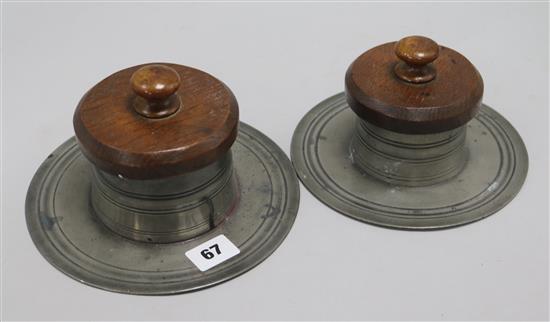 A pair of pewter inkwells